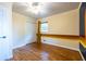 Bright bedroom with ceiling fan, closet, hardwood floors, and a unique retro-themed painted accent wall at 991 Columbia Dr, Decatur, GA 30030