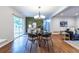 Open dining area with a glass table, backyard views, and seamless access to the living area at 991 Columbia Dr, Decatur, GA 30030