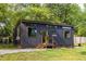 Stylish tiny home exterior with wood siding, large windows, and gravel landscaping at 991 Columbia Dr, Decatur, GA 30030