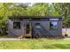 Modern tiny home exterior with dark wood siding, contrasting trim, and inviting entry porch at 991 Columbia Dr, Decatur, GA 30030