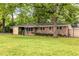 Charming brick home with a well-manicured lawn and mature trees at 991 Columbia Dr, Decatur, GA 30030