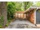 Side yard of the house with a gravel area and wooden fence at 991 Columbia Dr, Decatur, GA 30030
