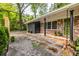 Charming single-story home featuring a brick exterior, dark trim, green door, and gravel landscaping at 991 Columbia Dr, Decatur, GA 30030