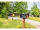 Charming single-story home with well-manicured lawn, mature trees, and a mailbox with visible address at 991 Columbia Dr, Decatur, GA 30030