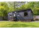Contemporary tiny home exterior with dark wood siding, lots of windows and a cozy patio space at 991 Columbia Dr, Decatur, GA 30030
