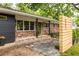 Exterior of brick home, wooden address accent, black columns, and green front door at 991 Columbia Dr, Decatur, GA 30030