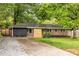 Street view of brick home with driveway, wooden address accent and green lawn at 991 Columbia Dr, Decatur, GA 30030
