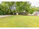 A lush front yard view shows the charming single-story home, mature trees and verdant green lawn at 991 Columbia Dr, Decatur, GA 30030