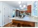 Kitchen with breakfast bar features stainless steel appliances, granite countertops, and modern pendant lighting at 991 Columbia Dr, Decatur, GA 30030