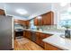 Bright kitchen featuring updated appliances, a neutral backsplash, hardwood floors, and modern fixtures at 991 Columbia Dr, Decatur, GA 30030