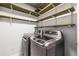 Efficient laundry room with modern washer and dryer, complemented by functional shelving at 991 Columbia Dr, Decatur, GA 30030