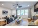 Bright living room featuring a modern ceiling fan, large windows, and contemporary furnishings at 991 Columbia Dr, Decatur, GA 30030