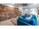 Inviting living room features an exposed brick wall and a comfortable blue sofa, perfect for relaxing at 991 Columbia Dr, Decatur, GA 30030