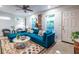 Comfortable living room with a modern blue sofa, patterned rug, and stylish decor at 991 Columbia Dr, Decatur, GA 30030