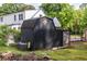 A black shed with decorative star offers backyard storage beside a white house with mature trees at 991 Columbia Dr, Decatur, GA 30030