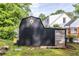A black shed with a decorative star accent provides stylish storage in the landscaped backyard at 991 Columbia Dr, Decatur, GA 30030
