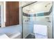 Elegant bathroom shower with white subway tile, mosaic accents, and glass door at 991 Columbia Dr, Decatur, GA 30030