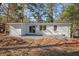 Backyard showcasing a white brick house with sliding glass doors and an area with stone at 331 Zelma Sw St, Marietta, GA 30060