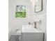 Well-lit bathroom featuring a vanity with a mirror and a tiled wall with a window at 331 Zelma Sw St, Marietta, GA 30060