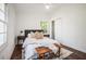 Cozy bedroom featuring hardwood floors, a ceiling fan, and a comfortable bed with stylish decor at 331 Zelma Sw St, Marietta, GA 30060