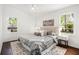 Spacious bedroom with two windows, a comfortable bed, stylish decor, and natural light at 331 Zelma Sw St, Marietta, GA 30060