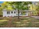 Charming white brick home with well-manicured lawn and covered front porch and driveway at 331 Zelma Sw St, Marietta, GA 30060