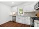 Modern kitchen featuring white cabinets, stainless steel appliances, and granite countertops at 331 Zelma Sw St, Marietta, GA 30060