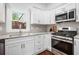 Modern kitchen featuring white cabinets, stainless steel appliances, and granite countertops at 331 Zelma Sw St, Marietta, GA 30060