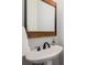 Modern bathroom with a stylish sink and wooden-framed mirror at 1143 Brookhaven North Cir, Brookhaven, GA 30319