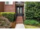 Elegant home entrance with brick steps and meticulously maintained landscaping at 1143 Brookhaven North Cir, Brookhaven, GA 30319
