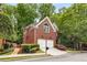Two-story brick home with a two-car garage, driveway, and manicured landscaping at 1143 Brookhaven North Cir, Brookhaven, GA 30319
