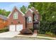 Charming brick home featuring a two-car garage and a beautifully landscaped front yard at 1143 Brookhaven North Cir, Brookhaven, GA 30319