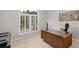 Home office area with a desk and a large window with white plantation shutters at 1143 Brookhaven North Cir, Brookhaven, GA 30319