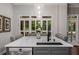 Kitchen island with white marble countertop and black faucet under decorative pendant lights at 1143 Brookhaven North Cir, Brookhaven, GA 30319
