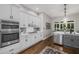 Well-lit kitchen featuring modern appliances, white cabinetry and a view to breakfast area at 1143 Brookhaven North Cir, Brookhaven, GA 30319