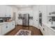 Bright modern kitchen with stainless steel appliances, white cabinetry, and wood floors at 1143 Brookhaven North Cir, Brookhaven, GA 30319