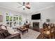 Cozy living room with a marble fireplace, ceiling fan, and view to outdoor patio at 1143 Brookhaven North Cir, Brookhaven, GA 30319
