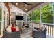 Cozy screened-in porch with wood ceiling and comfortable wicker furniture at 1143 Brookhaven North Cir, Brookhaven, GA 30319