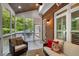 Inviting screened-in porch with brick exterior and comfortable seating arrangement at 1143 Brookhaven North Cir, Brookhaven, GA 30319