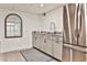 Finished basement with a sink, stainless refrigerator, granite counters, and unique herringbone flooring at 1658 East Clifton Rd, Atlanta, GA 30307