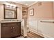 Charming bathroom with wood paneled walls, dark wood cabinets and a granite countertop at 1658 East Clifton Rd, Atlanta, GA 30307