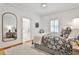 Cozy bedroom featuring a decorative mirror, shuttered windows, and soothing decor at 1658 East Clifton Rd, Atlanta, GA 30307
