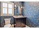 Stylish powder room with designer wallpaper, vanity, and elegant lighting fixtures at 1658 East Clifton Rd, Atlanta, GA 30307