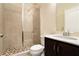 Modern bathroom with glass enclosed shower and single sink vanity with marble countertop at 169 Waterman Se St, Marietta, GA 30060