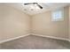 Bedroom with a carpeted floor, neutral walls, white trim, and a bright window with plantation shutters at 169 Waterman Se St, Marietta, GA 30060