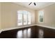 Bright bedroom featuring hardwood floors, crown molding, and a large window with plantation shutters at 169 Waterman Se St, Marietta, GA 30060