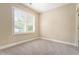 Bright bedroom with a large window and neutral walls complemented by carpet flooring at 169 Waterman Se St, Marietta, GA 30060