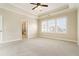 Bedroom featuring carpeted floor and tray ceiling with white trim, connecting to the ensuite bathroom at 169 Waterman Se St, Marietta, GA 30060
