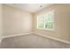 Bedroom featuring carpeted floor and a bright window with plantation shutters at 169 Waterman Se St, Marietta, GA 30060