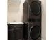 Compact laundry area with stacked washer/dryer and dark cabinetry at 169 Waterman Se St, Marietta, GA 30060